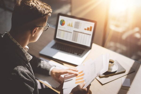 Man looking at data and graphs.