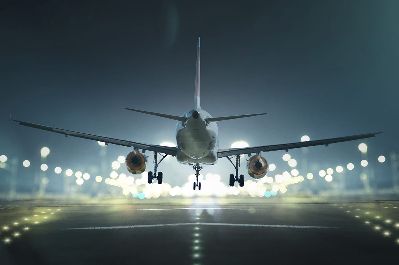 Airplane taking off or landing from runway at night.