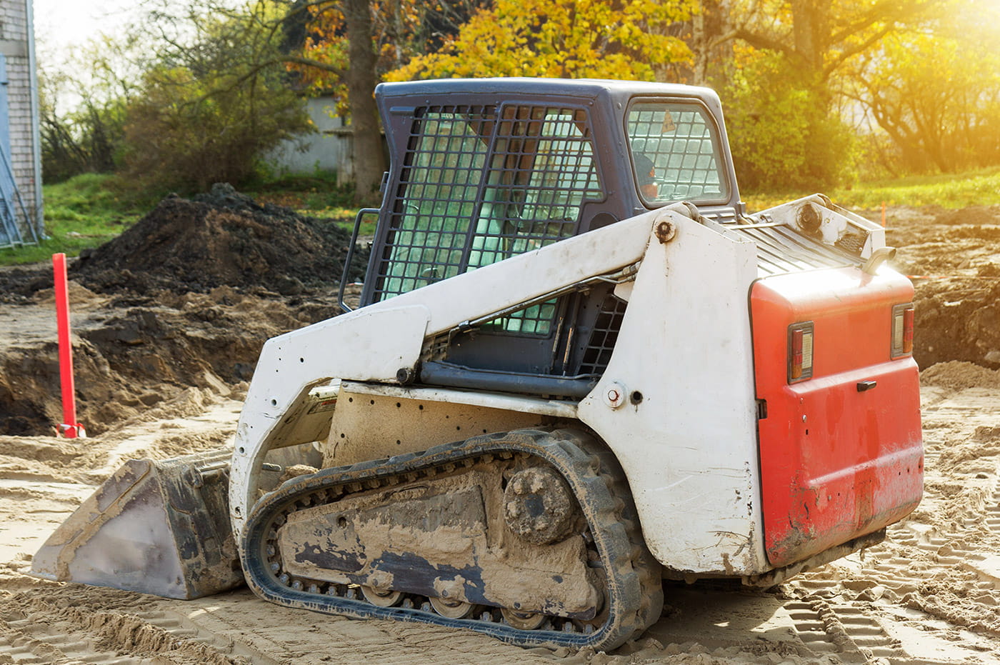 Bobcat excavator truck digging a hole in the ground.