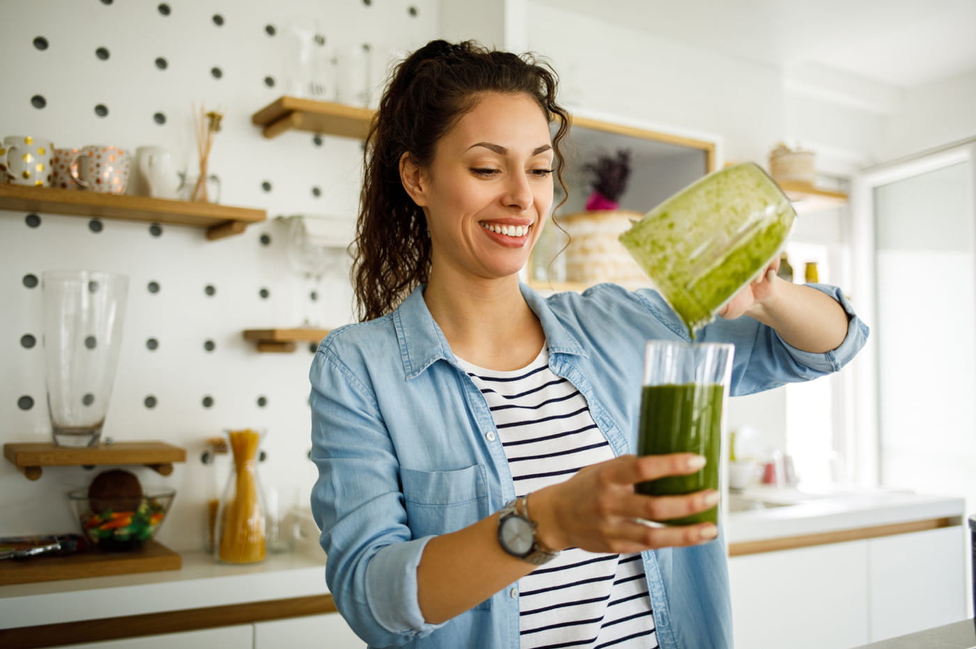 Woman pouring a smoothie