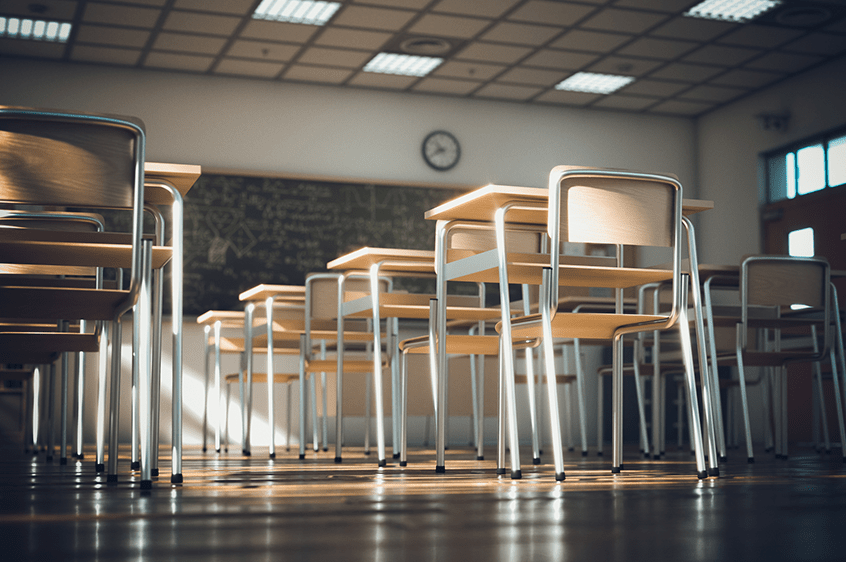 An empty classroom full of desks and chairs.