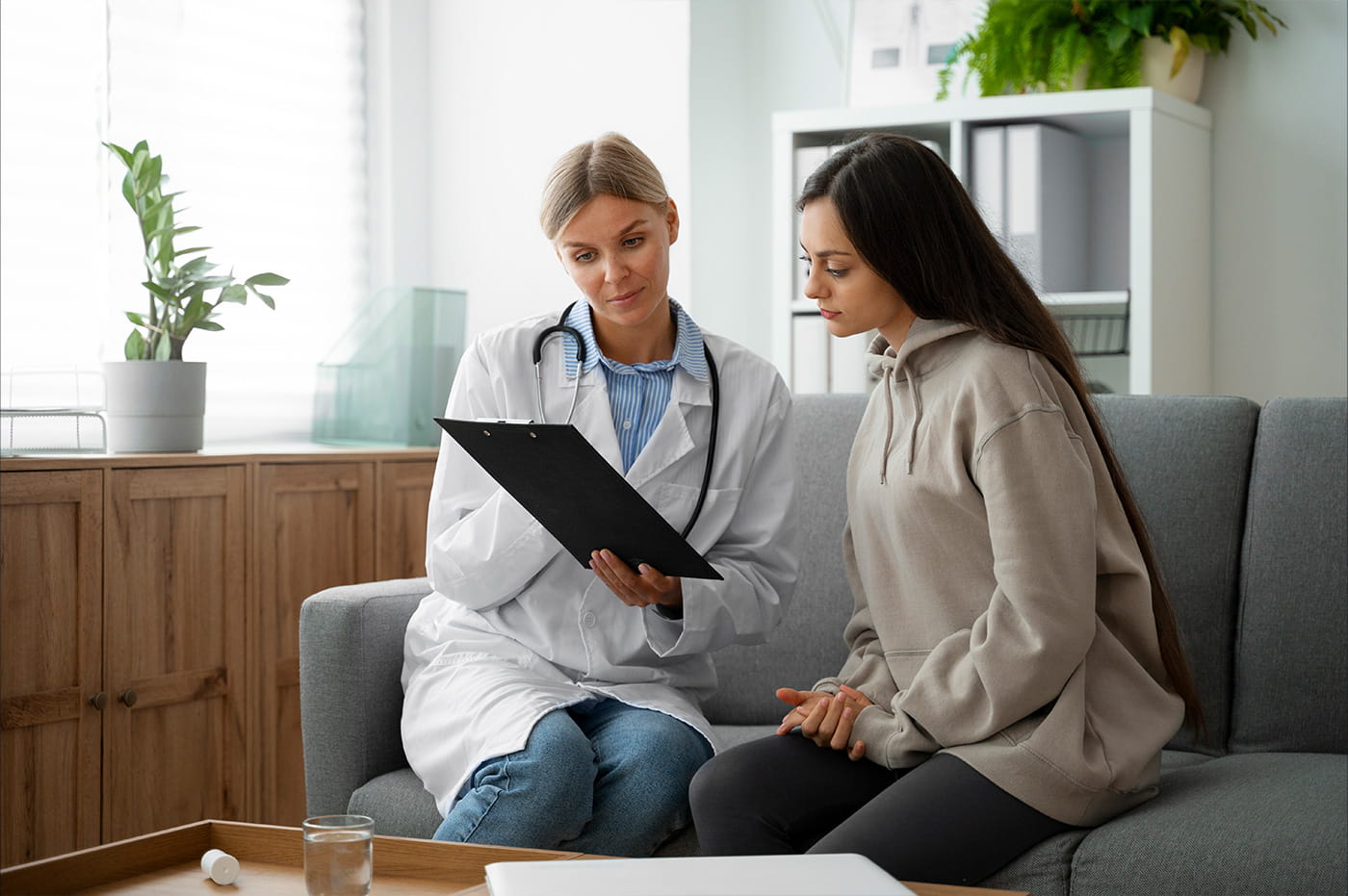 A doctor and patient going over information on a tablet.