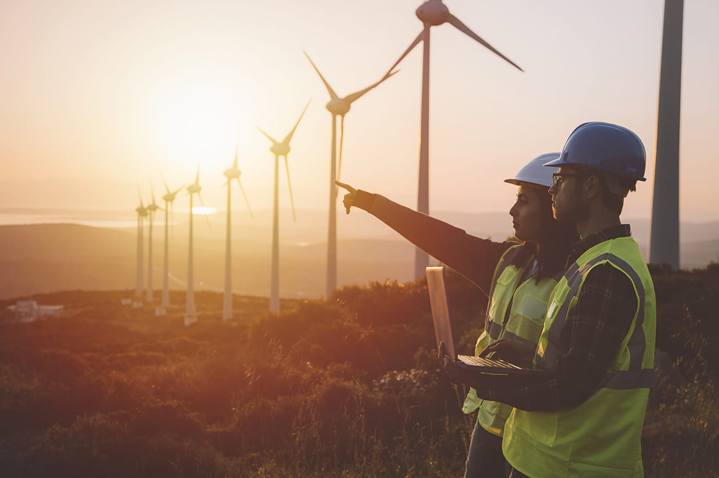 Two workers at a windmill farm 