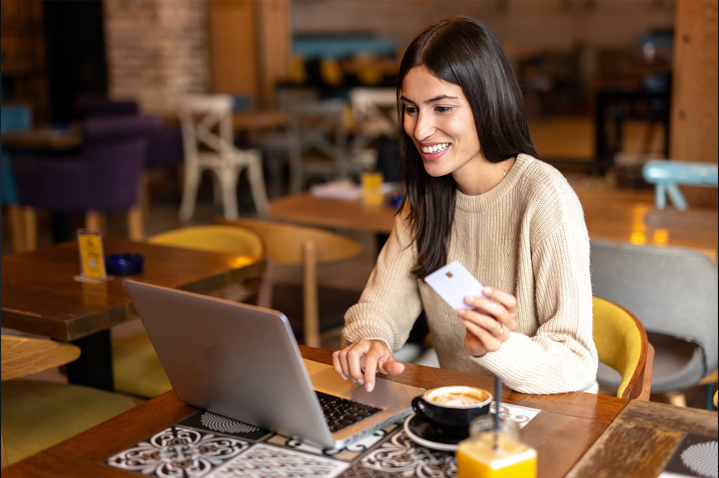 A woman using a credit card to shop online.