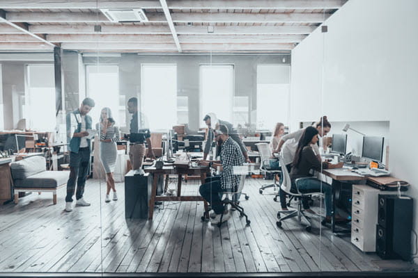 Group of young business people in smart casual wear working together in creative office