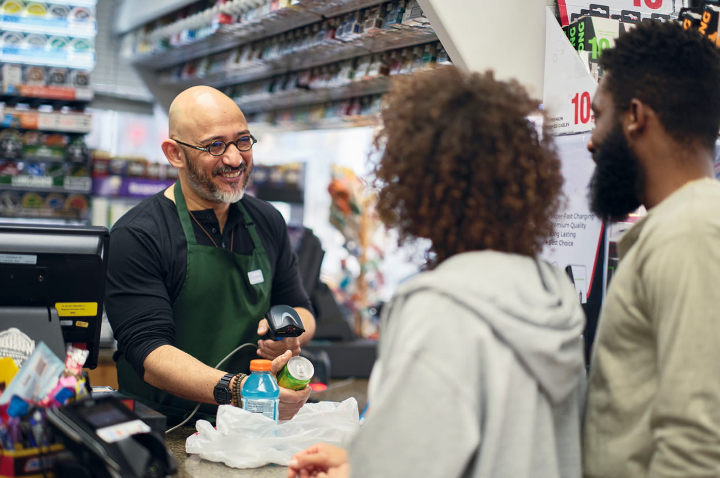 Customers checking out at a convenience store.